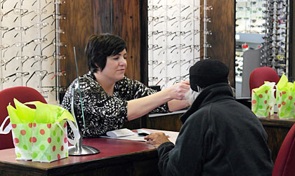 Amber helping a patient with eyewear